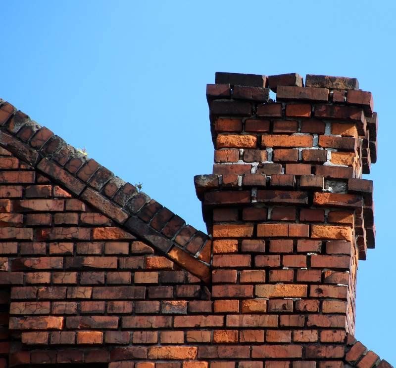 Damaged chimney on an Lynn home showing cracks and missing mortar